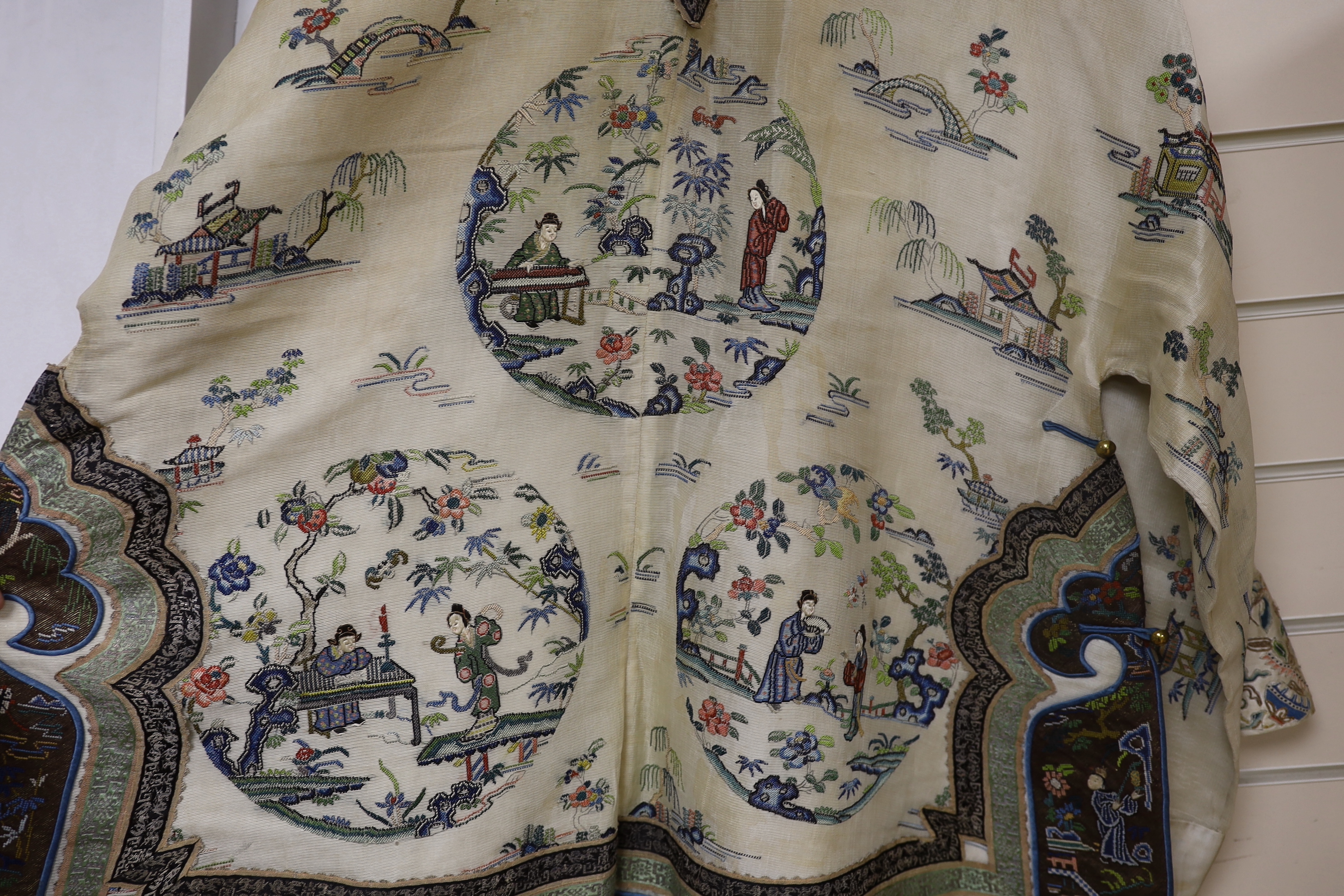 A late 19th/early 20th century Chinese gauze summer robe embroidered with flowers, figures and pagodas, 85cm high